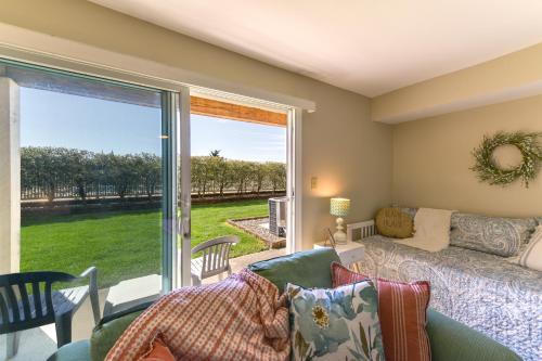 a living room with a couch and a large window at Brigantine Condo with Beach Access and Pool Views in Brigantine