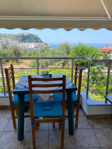 a table and chairs on a balcony with a view at Rexhos Studios in Himare