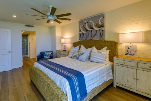 a bedroom with a large bed with a ceiling fan at Port Aransas Vacation Rental with Pools - Near Beach in Port Aransas