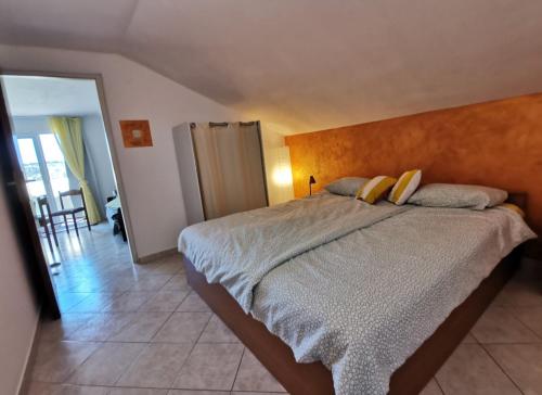 a bedroom with a large bed with yellow pillows at Tina's holiday house in Vela Luka