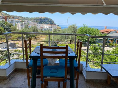 a table and chairs on the balcony of a house at Rexhos Studios in Himare