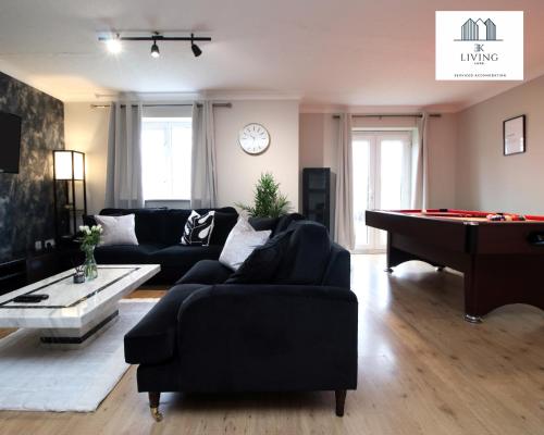 a living room with a couch and a pool table at Spacious 3 Bedroom Duplex Apartment On Cardiff Bay - Free Private Parking - By EKLIVING LUXE in Cardiff