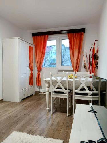 a dining room with a table and a window at Lend City Apartment in Miercurea-Ciuc