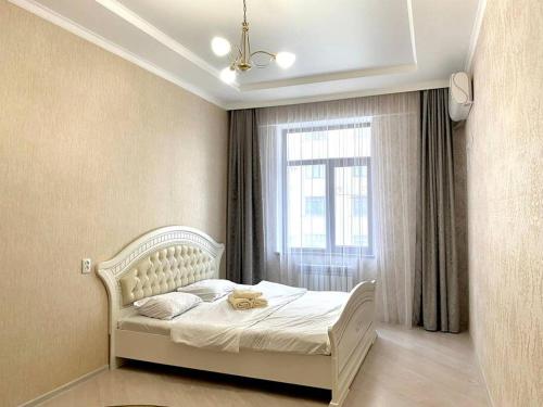 Postel nebo postele na pokoji v ubytování Уютная квартира в центре города