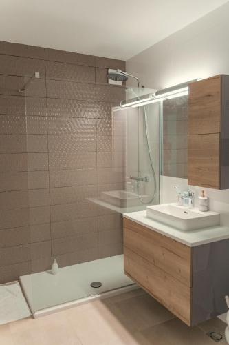 a bathroom with a sink and a shower at Dedaj Resort - Villa Tina in Zadar