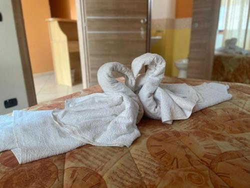 dos toallas sentadas encima de una cama en MANDANICI :Borgo Marsalini, en Barcellona-Pozzo di Gotto