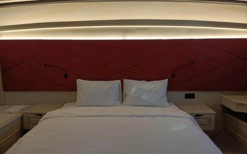 a bedroom with a large bed with a red headboard at Arielle 1 - Lüks Tekne in Fethiye