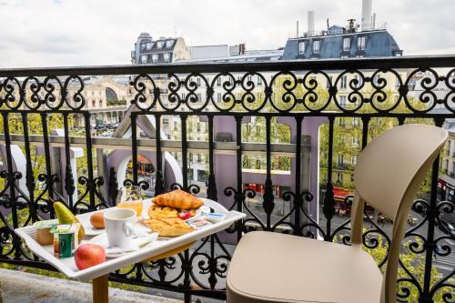 - un plateau de nourriture sur une table sur un balcon dans l'établissement Hôtel D'Alsace, à Paris