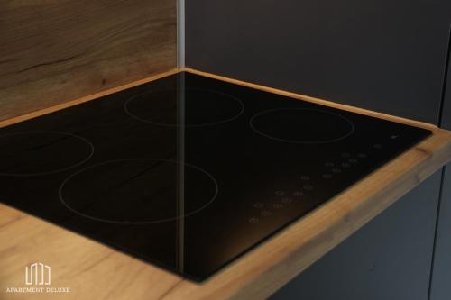 a black box with a wooden top on a wooden floor at Apartment Deluxe in Jajce
