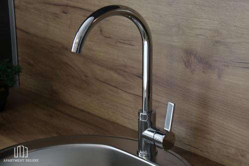 a kitchen sink with a chrome kitchen faucet at Apartment Deluxe in Jajce