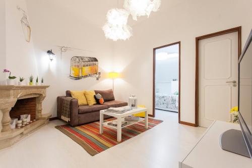 a living room with a couch and a fireplace at Ginjinha House - 4 Rooms - Bairro Alto - with AC by Lisbeyond in Lisbon