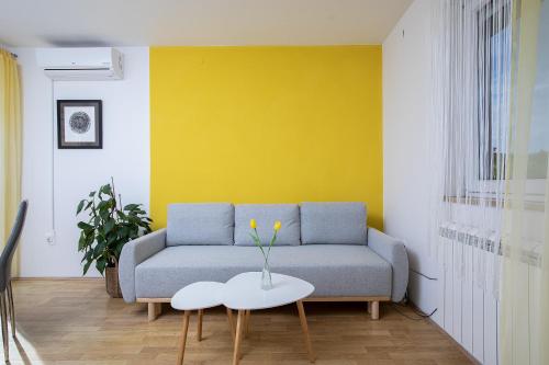 a living room with a couch and a table at Pula Istria Apartments in Pula