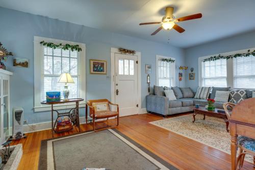 a living room with a couch and a ceiling fan at Charming Canyon Lake Cottage with Pool and BBQ Pit! in Canyon Lake