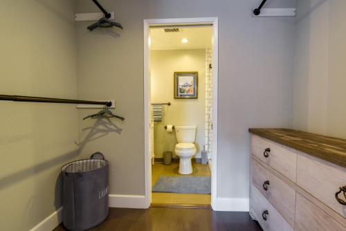a bathroom with a toilet and a hallway at San Francisco Getaway Near Golden Gate Park in San Francisco