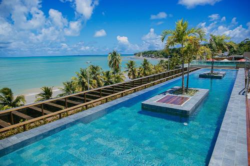 a swimming pool with a view of the beach at Unity #423 - Elegância à beira-mar por Carpediem in Penha