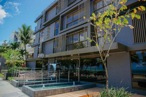 a building with a pool in front of it at Unity #423 - Elegância à beira-mar por Carpediem in Penha