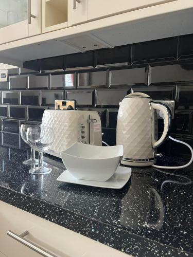 a kitchen counter with a tea pot and a bowl on it at Beautifully presented Victorian Apartment within walking distance to Llandudno beach in Llandudno