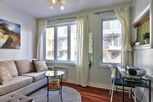 a living room with a couch and a table at Apartment et Studio montreal in Montreal