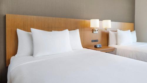 a hotel room with two beds with white pillows at Hyatt Place Jacksonville St. Johns Town Center in Jacksonville