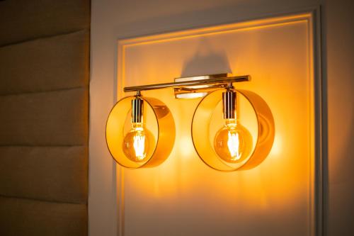 a light fixture with two lights on a wall at Casa do Estanco in Quiroga