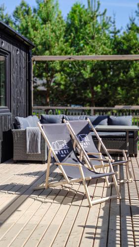 a pair of lawn chairs sitting on a deck at Wynki no. 69 in Łukta