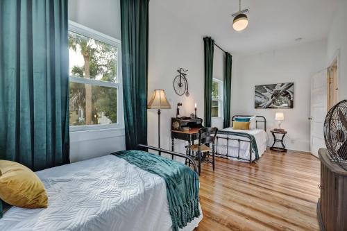 a bedroom with a bed and a desk and a window at The Gatsby Mansion Heated Pool Heart of Town in Saint Augustine