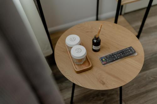 a table with a bottle of beer and a remote control at No. 55 in Buzau