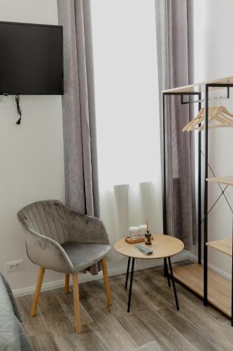 a living room with a chair and a table at No. 55 in Buzau
