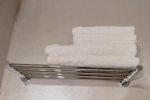 a towel rack with towels on it in a bathroom at No. 55 in Buzau