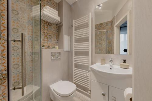 a bathroom with a toilet and a sink and a shower at No. 55 in Buzau