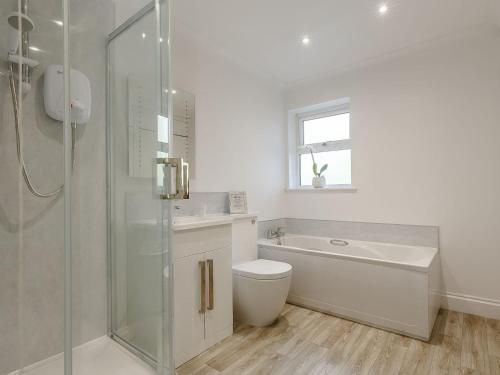 a bathroom with a toilet and a sink and a shower at Highgrove in Gissing