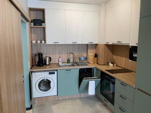 a kitchen with a washing machine and a washer at Dream_Apartment in Varna City