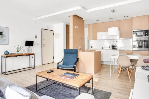 a living room and kitchen with a table and chairs at Modern 2 Bedroom Apartment in Estrela with Outside Terrace! Amazing for Families, Couples, Friends in Lisbon