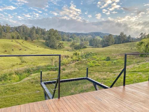a balcony with a view of a field and trees at Bohemia Glamping in La Unión