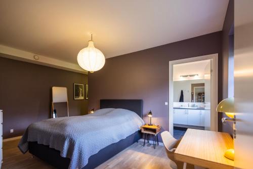 a bedroom with a large bed and a table at Lake House Central Lyngby in Kongens Lyngby