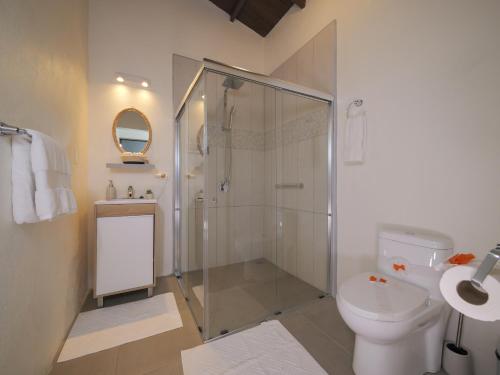 a bathroom with a shower and a toilet and a sink at Villas El Beach Club in Santa Cruz