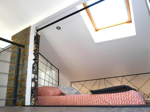 a bedroom with two beds and a skylight at L'Oriflamme in Avignon