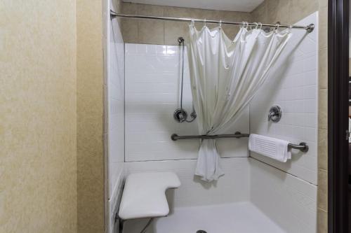 a bathroom with a shower with a toilet and a sink at Motel 6 Minot, ND in Minot