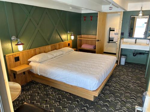 a bedroom with a large bed and a sink at The Hostel in Teton Village