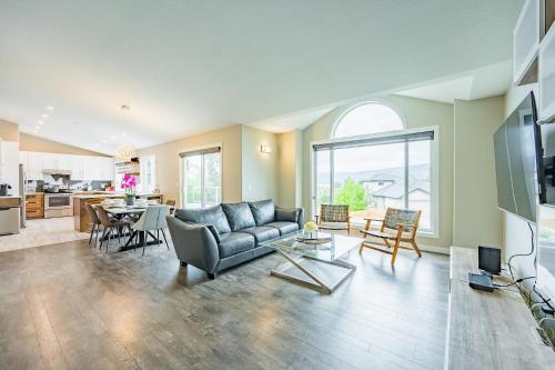 a living room with a couch and a table at Cozy 5BD House in North Mission Crawford in Kelowna
