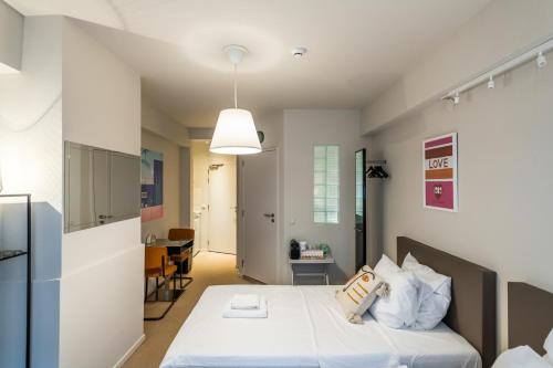 a bedroom with a bed with white sheets and pillows at Japie rooms - in the heart of Antwerp in Antwerp