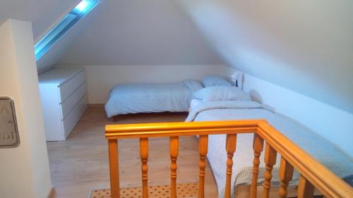 a room with two twin beds in a attic at Búzavirág házikó in Cserszegtomaj