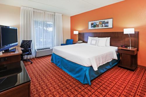 a hotel room with a large bed and a flat screen tv at Fairfield Inn and Suites by Marriott Austin Northwest/The Domain Area in Austin