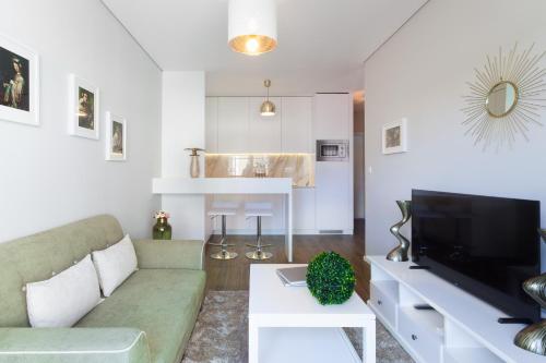 a living room with a couch and a tv at Urban Views - ML inspired by Torre dos Clérigos in Porto