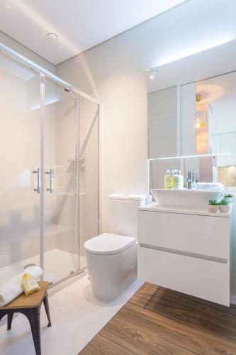 a bathroom with a shower and a toilet and a sink at Urban Views - ML inspired by Torre dos Clérigos in Porto