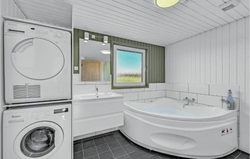 a white bathroom with a washing machine and a sink at Lovely Home In Ringkbing With Wifi in Søndervig