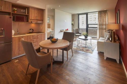 a kitchen and living room with a table and chairs at Caluce Apt 3B by Letoh in Chía