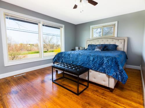 a bedroom with a bed and two windows at The Grand Gorge Villa-With Private Yard & Parking, Minutes From Falls & Casino by Niagara Hospitaliy in Niagara Falls