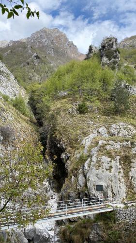 a bridge over a mountain with a cave in it at B&B Gronda Via Vandelli in Massa