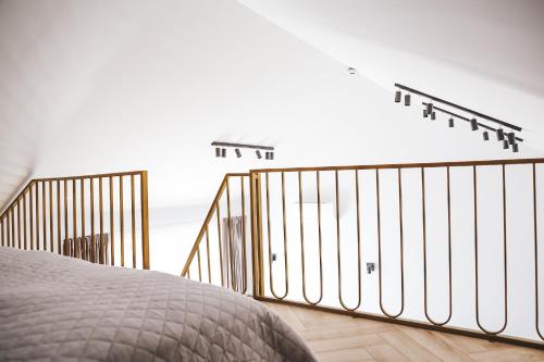 a bedroom with a bed and a balcony with the ocean at Genio apartamentai Kunigiskiuose in Palanga